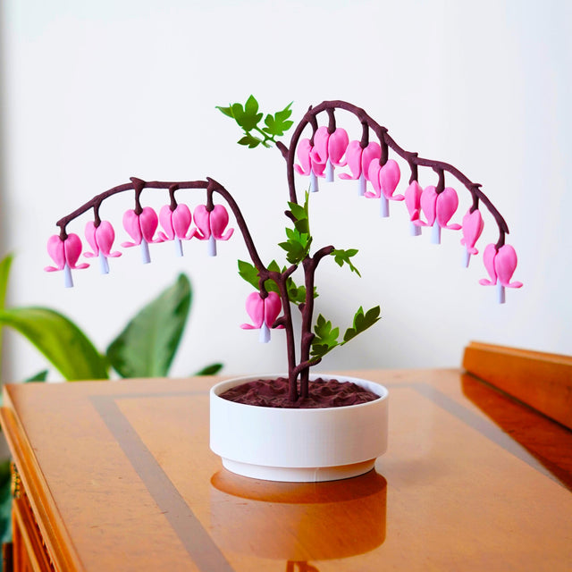 3D-printed Bleeding Hearts jewelry box with pink flowers and green leaves in a white pot, perfect romantic gift decor.