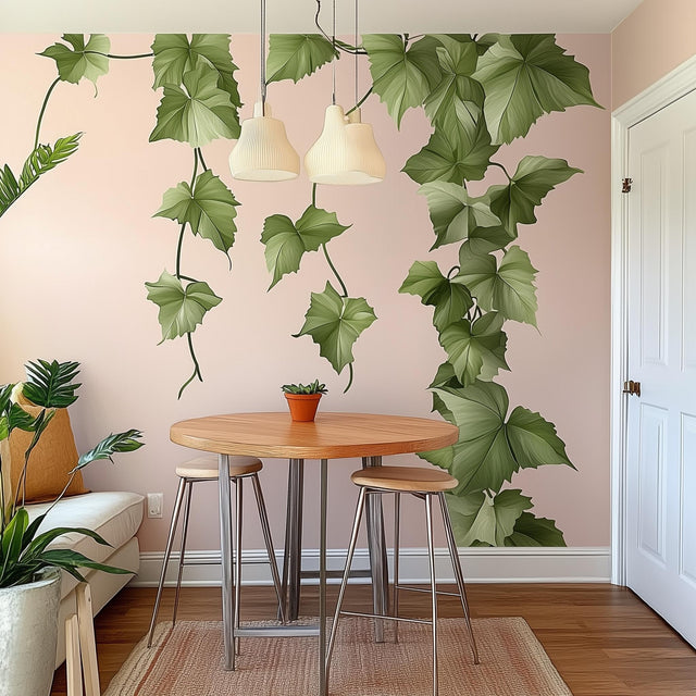 Hanging vine wall decal in a cozy dining room, featuring cascading green leaves on a light pink wall, enhancing the space.