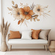 Boho floral wall decal featuring watercolor flowers in warm tones above a cozy sofa with decorative pillows.