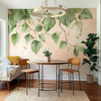Leafy branch wall decal sticker in a dining area with modern decor and a round table.
