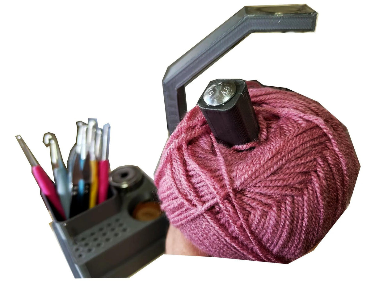 3D printed crochet tools organizer with yarn spinner featuring crochet hooks and yarn ball for easy crafting.