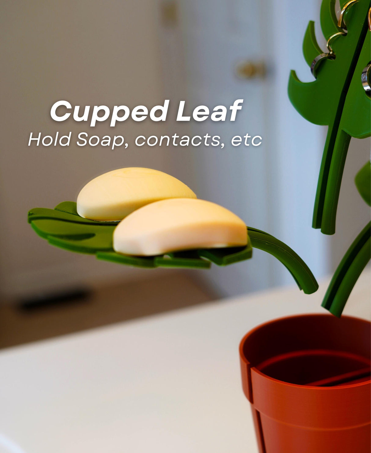 Cupped leaf of the Mirror Monstera Organizer holding soap in a stylish bathroom storage solution.