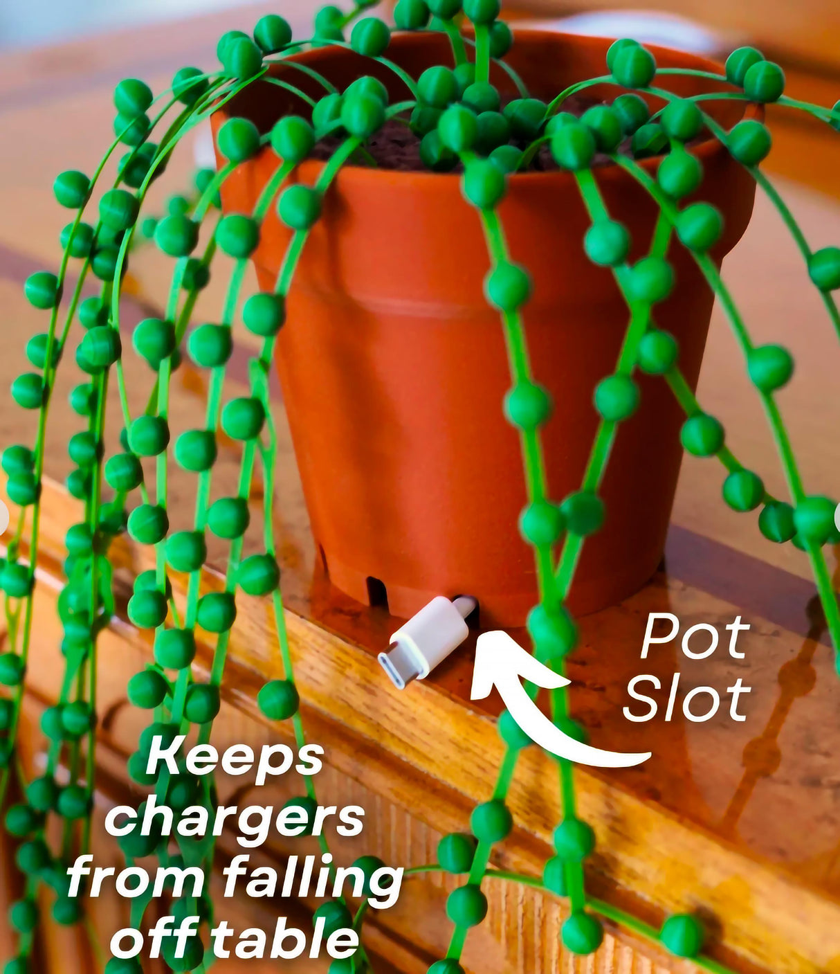 String of Pearls cable organizer displaying green ties and charger pot slot to prevent cords from falling off the table.