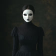 Elegant gothic woman wearing a white phantom mask and dark Victorian dress, perfect for masquerade and Halloween.