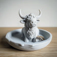 3D printed highland cow ring holder on a trinket dish, perfect for organizing jewelry in farmhouse decor.