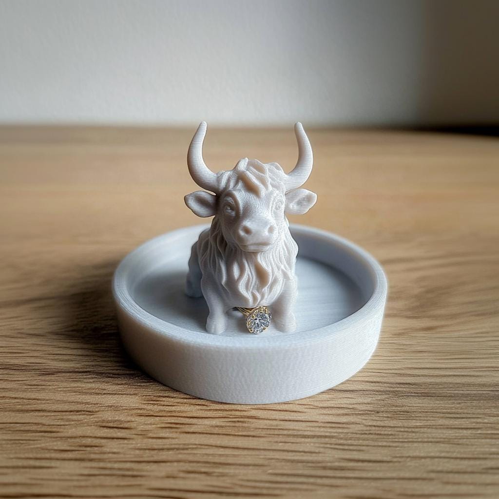 Highland cow 3D printed jewelry dish, charming ring holder on wooden surface, rustic farmhouse decor for accessories.
