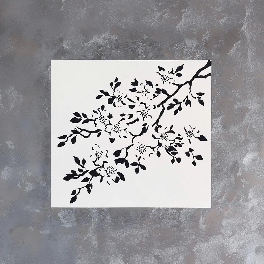 Cherry blossom stencil design on a white background, featuring intricate floral branches and leaves.