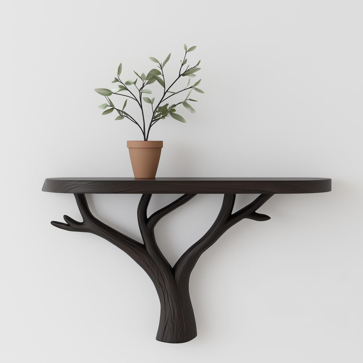 Tree branch wall shelf with a black matte finish and a potted plant, showcasing modern minimalist design.