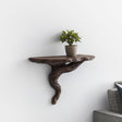3D printed twisted root wall shelf with a potted plant, adding rustic decor to a modern living space.