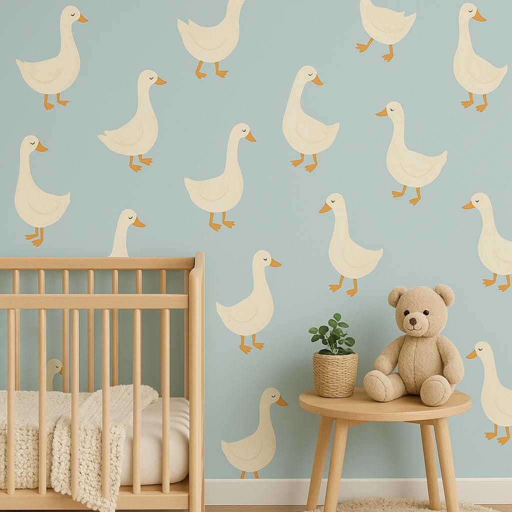 Whimsical goose wall decals in a nursery with a crib and teddy bear for playful baby room decor.