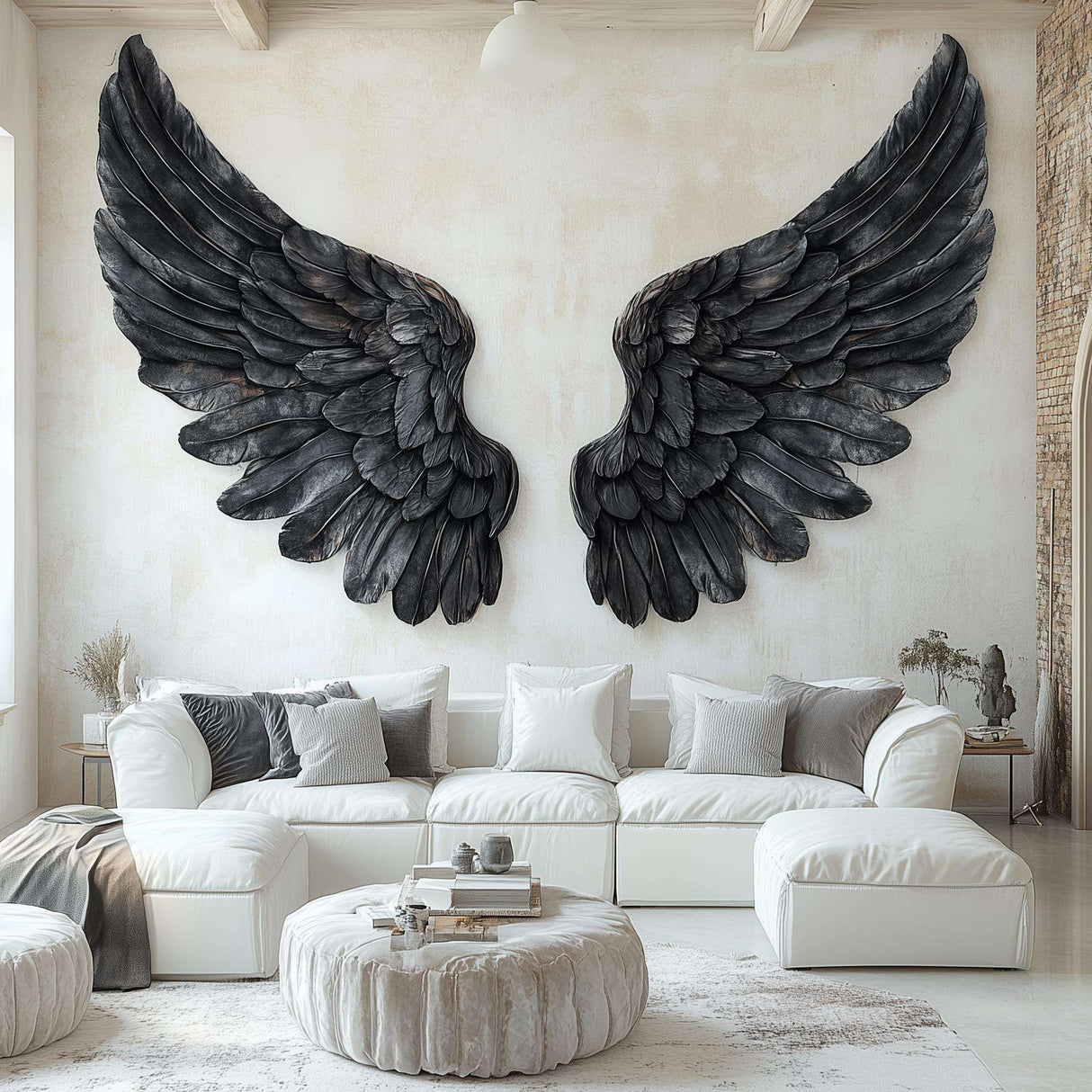 Large black angel wings wall decal applied to a living room wall above a white sectional couch, with detailed feather textures and a gothic-modern aesthetic.