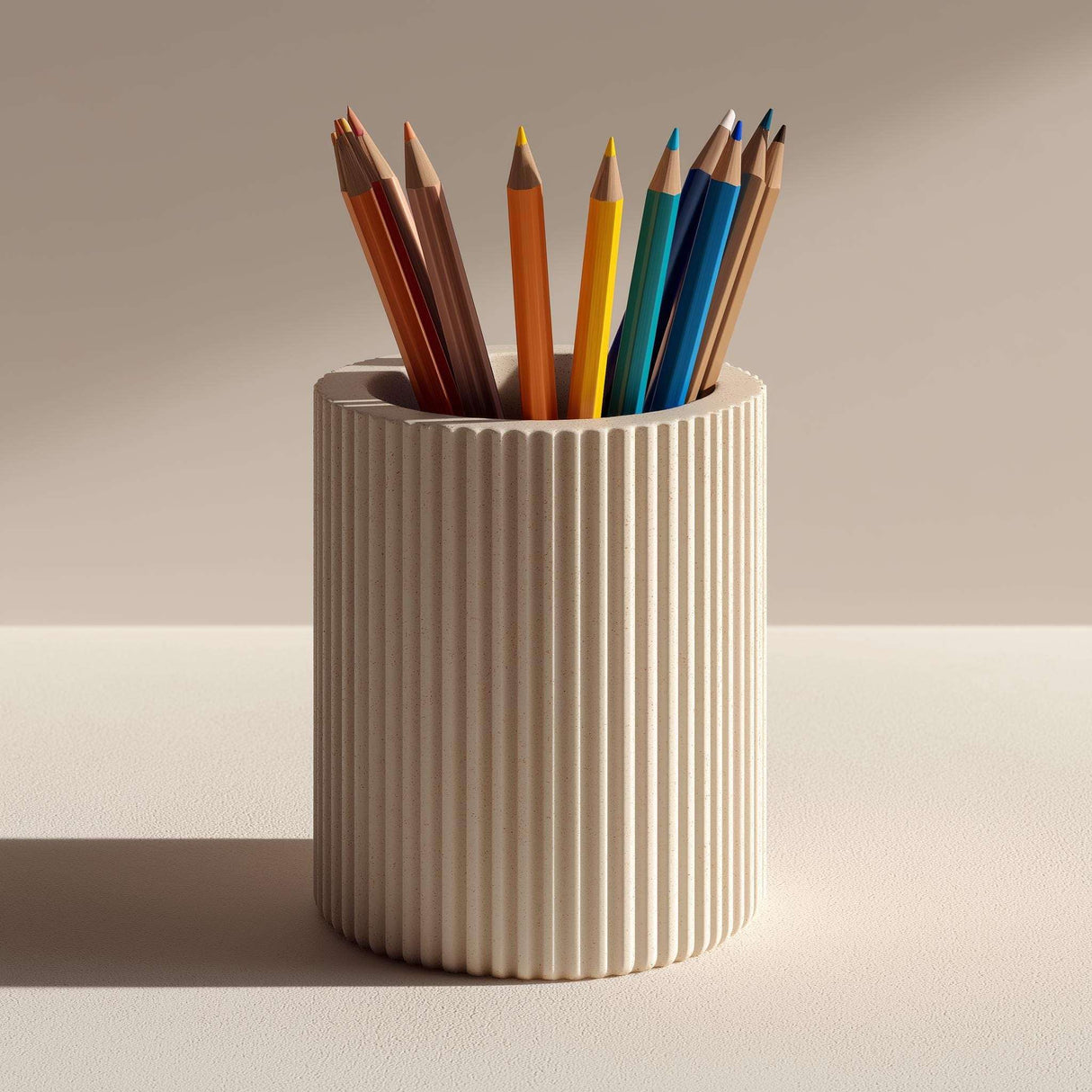 Cream-colored cylindrical 3D printed pencil holder with vertical ribbed grooves, shown with colorful pencils for illustration; pencils are not included.