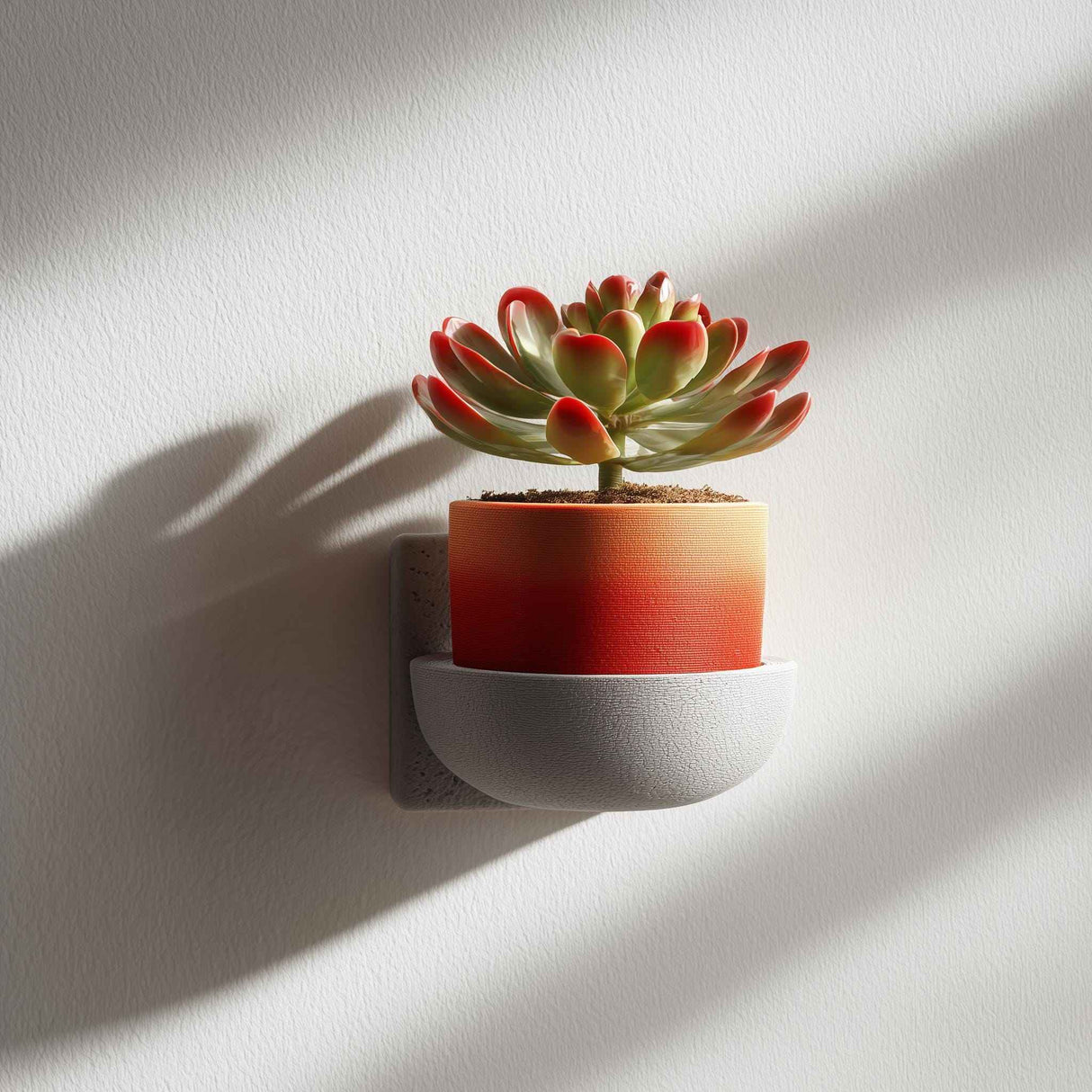 3D printed mug-style flowerpot shelf in gray, holding a small plant in a colorful pot, mounted on a wall as modern minimalist decor