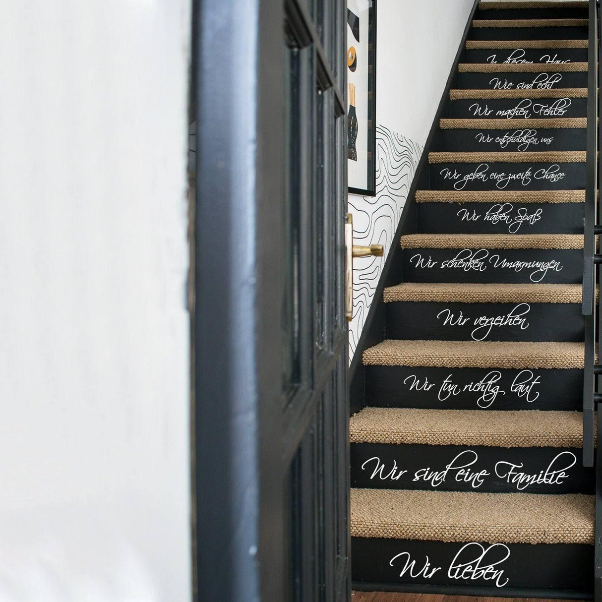 Stair vinyl decal featuring elegant family quotes for home decor in stylish black and white design.