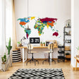 Vibrant world map wall sticker in modern workspace with desk and plants, ideal for geography lovers and decor.