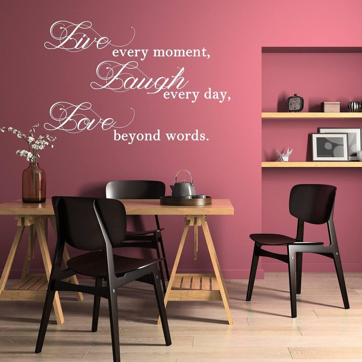Elegant vinyl decal with inspiring quote 'Live Laugh Love' on a pink wall in a modern dining area.