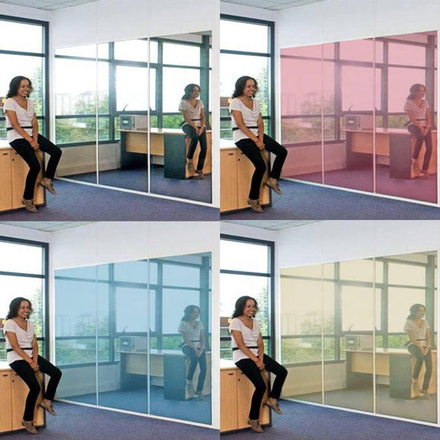 Woman using mirror privacy window film in office; showcasing blue and pink options for stylish privacy solutions.