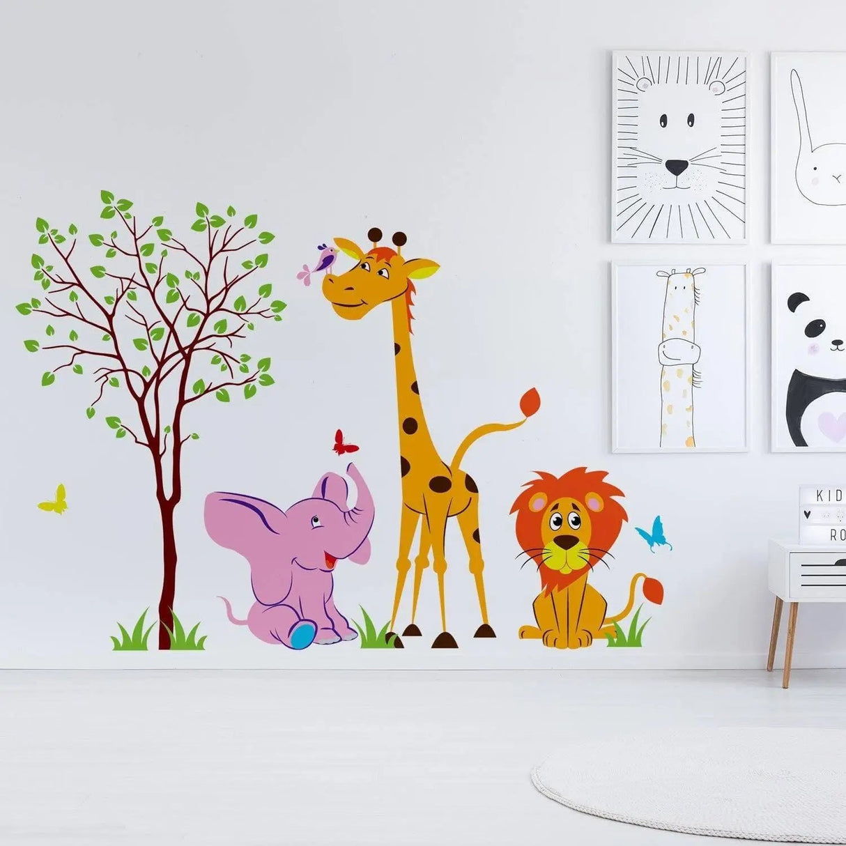 Colorful safari animal wall decal featuring a giraffe, elephant, and lion beside a tree, perfect for nursery decor.