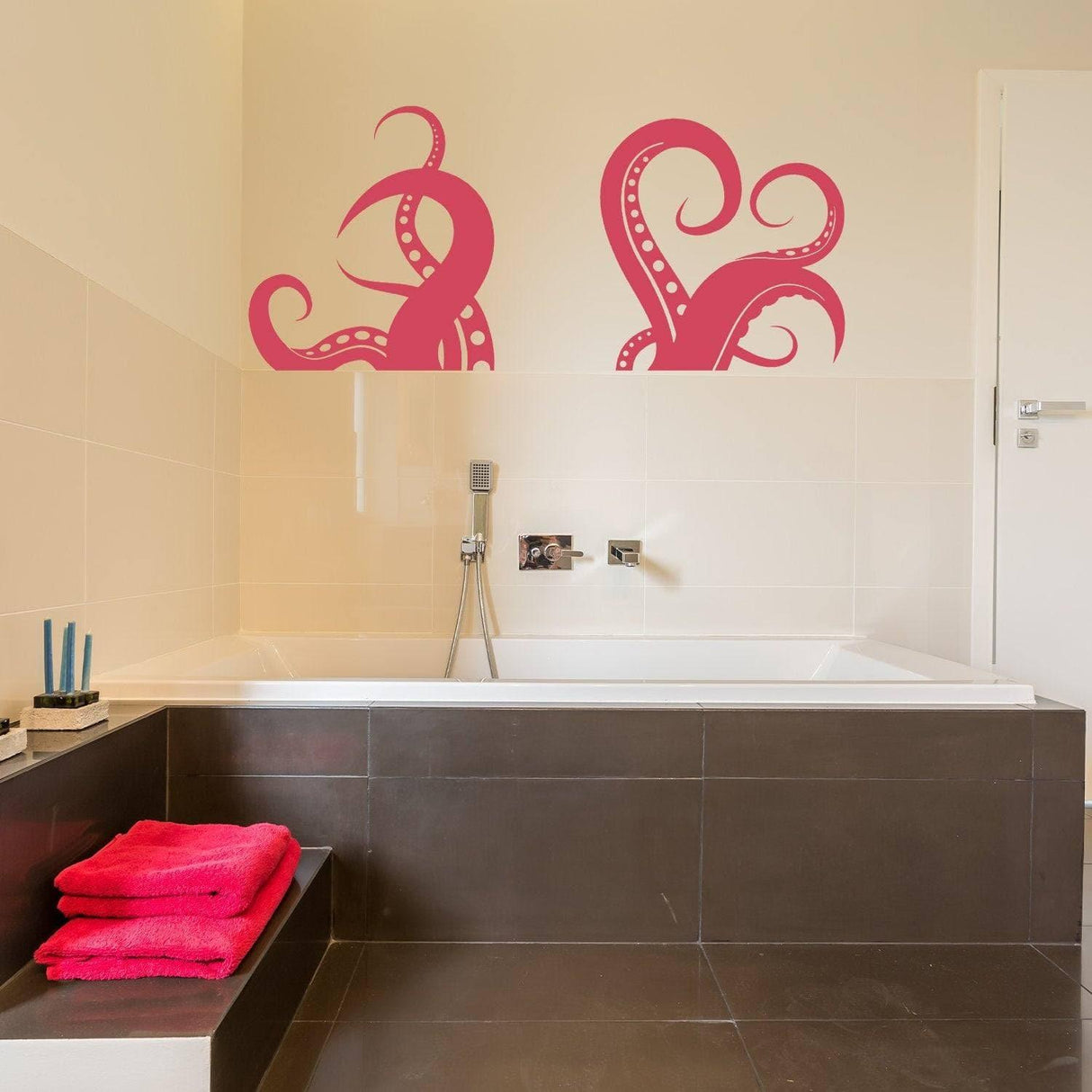 Octopus vinyl wall sticker in a bathroom above a bathtub, featuring marine-themed design in pink.