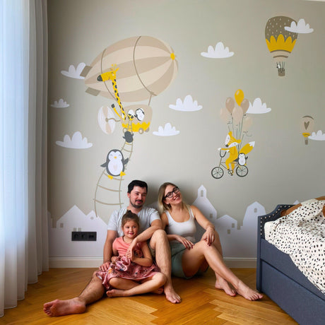 Family enjoying adorable animal wall stickers featuring penguins and balloons in a cozy children's room.