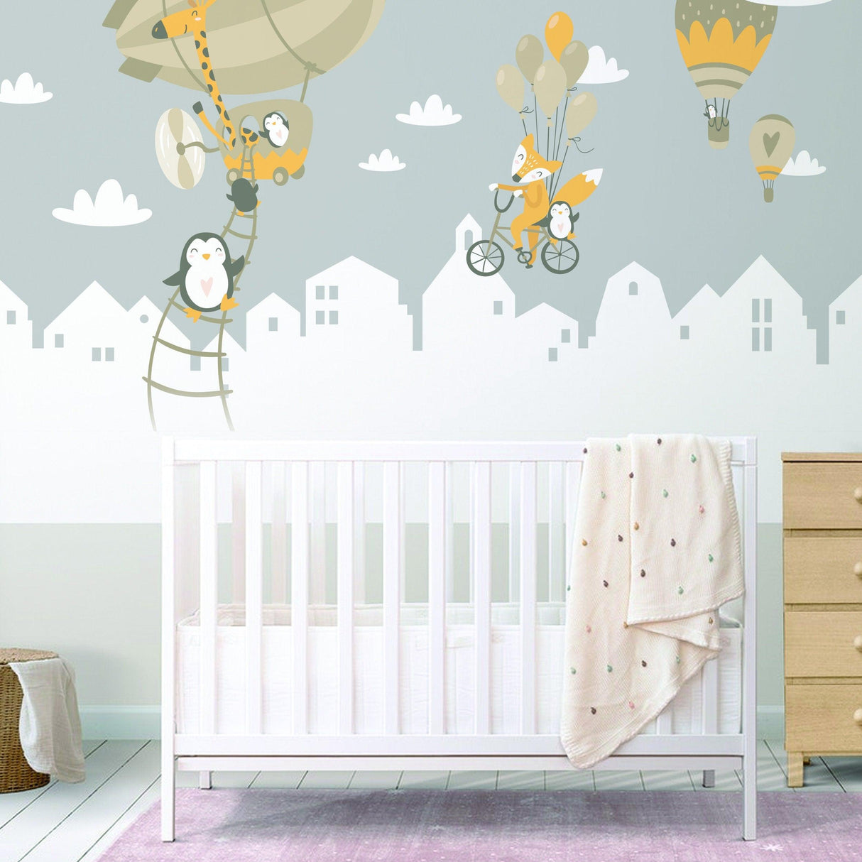 Whimsical animal wall stickers featuring penguins and a fox with hot air balloons, perfect for a nursery or kid's room.