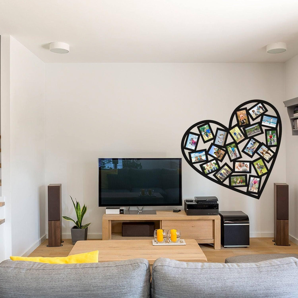 Heart-shaped picture frame decal on a wall above a modern living room TV setup with cozy furniture.