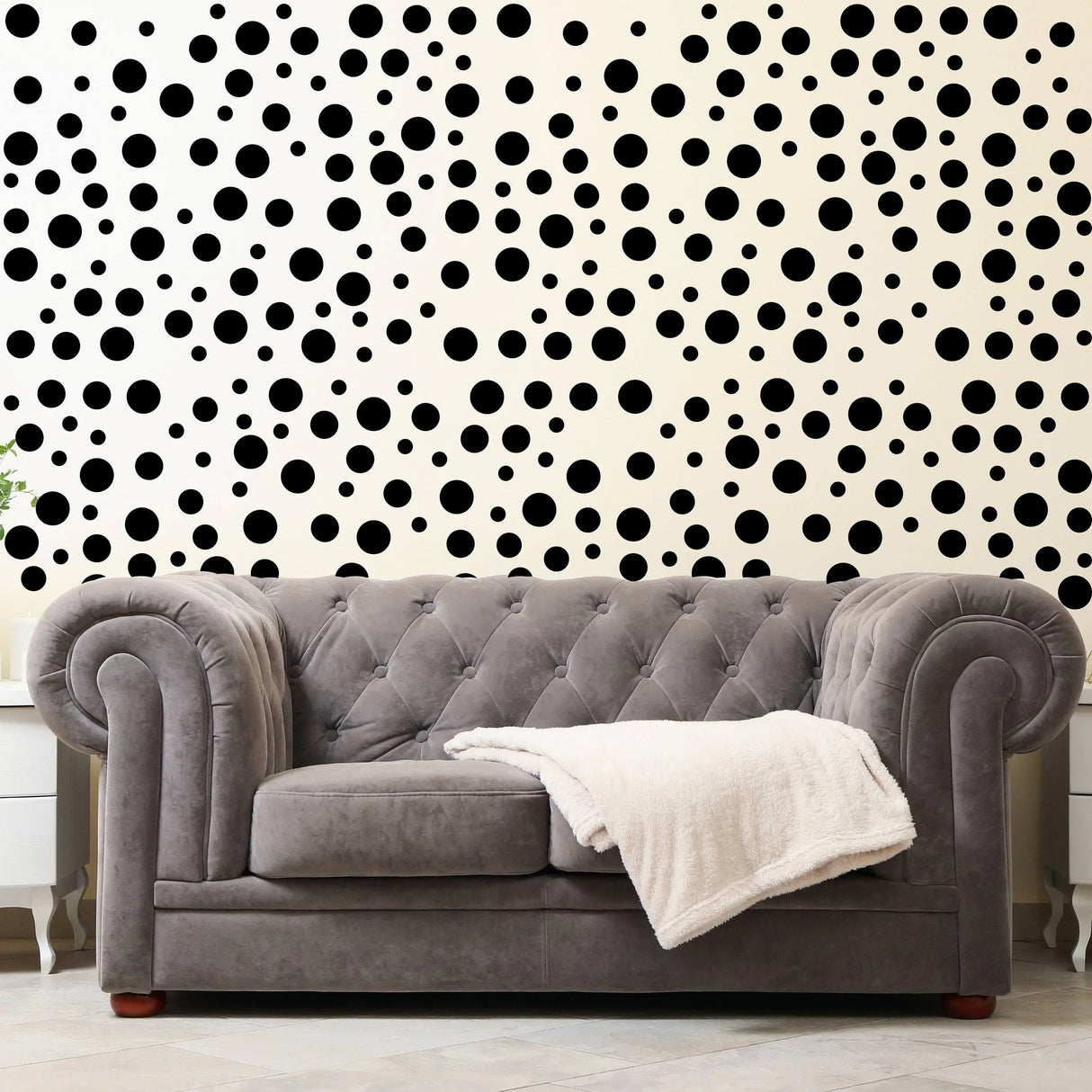 Stylish black polka dot wall decals behind a cozy grey sofa, creating a whimsical atmosphere.