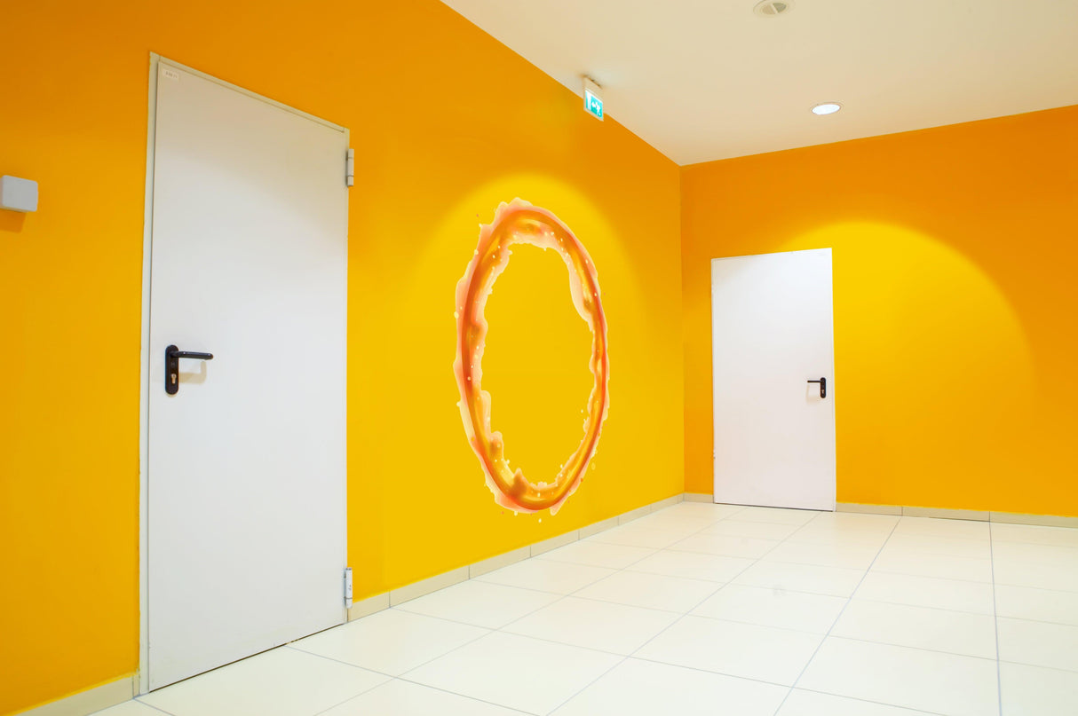 Vibrant orange wall featuring a circular portal decal, enhancing game room decor.