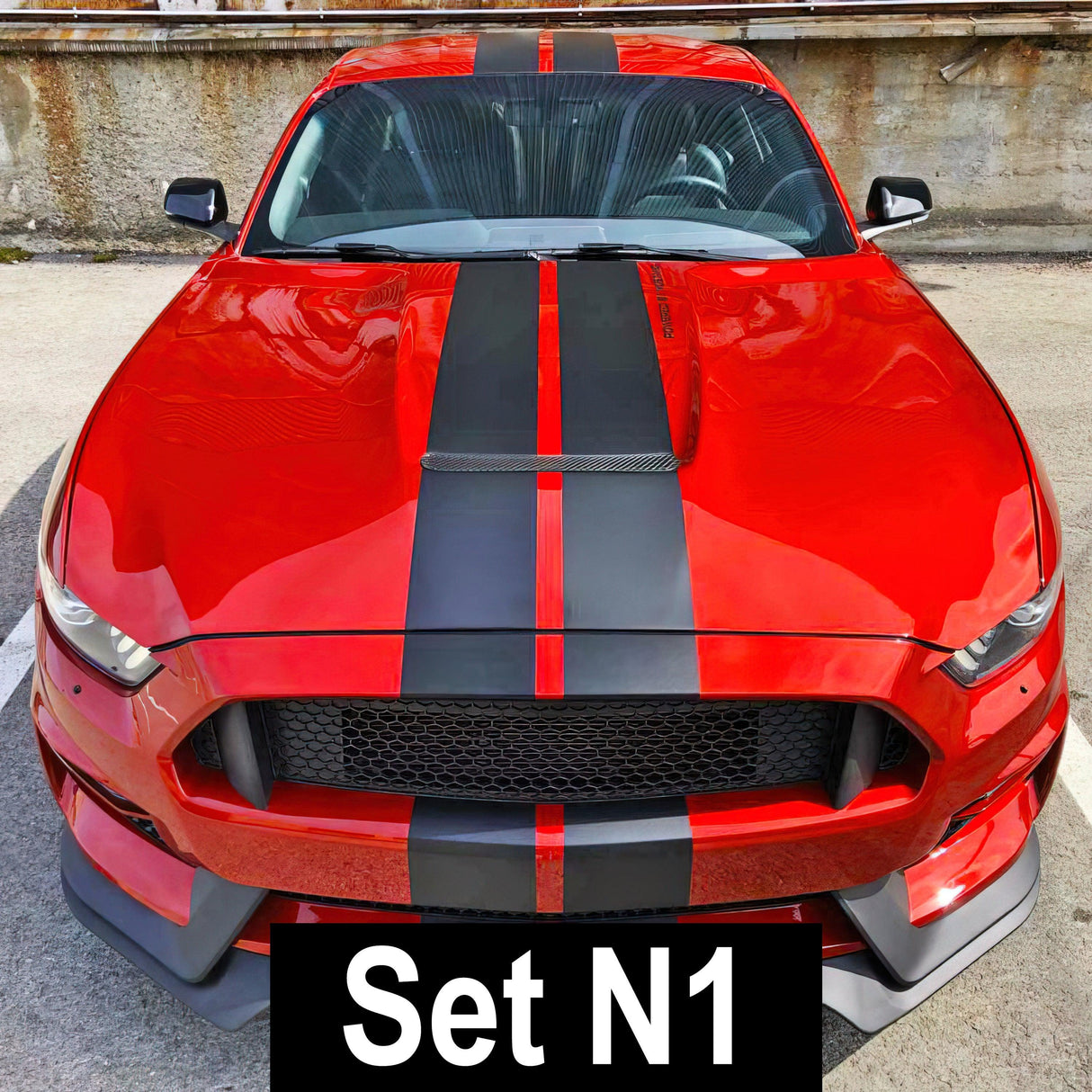 Red sports car with black racing stripes vinyl decals for a sleek, stylish upgrade.