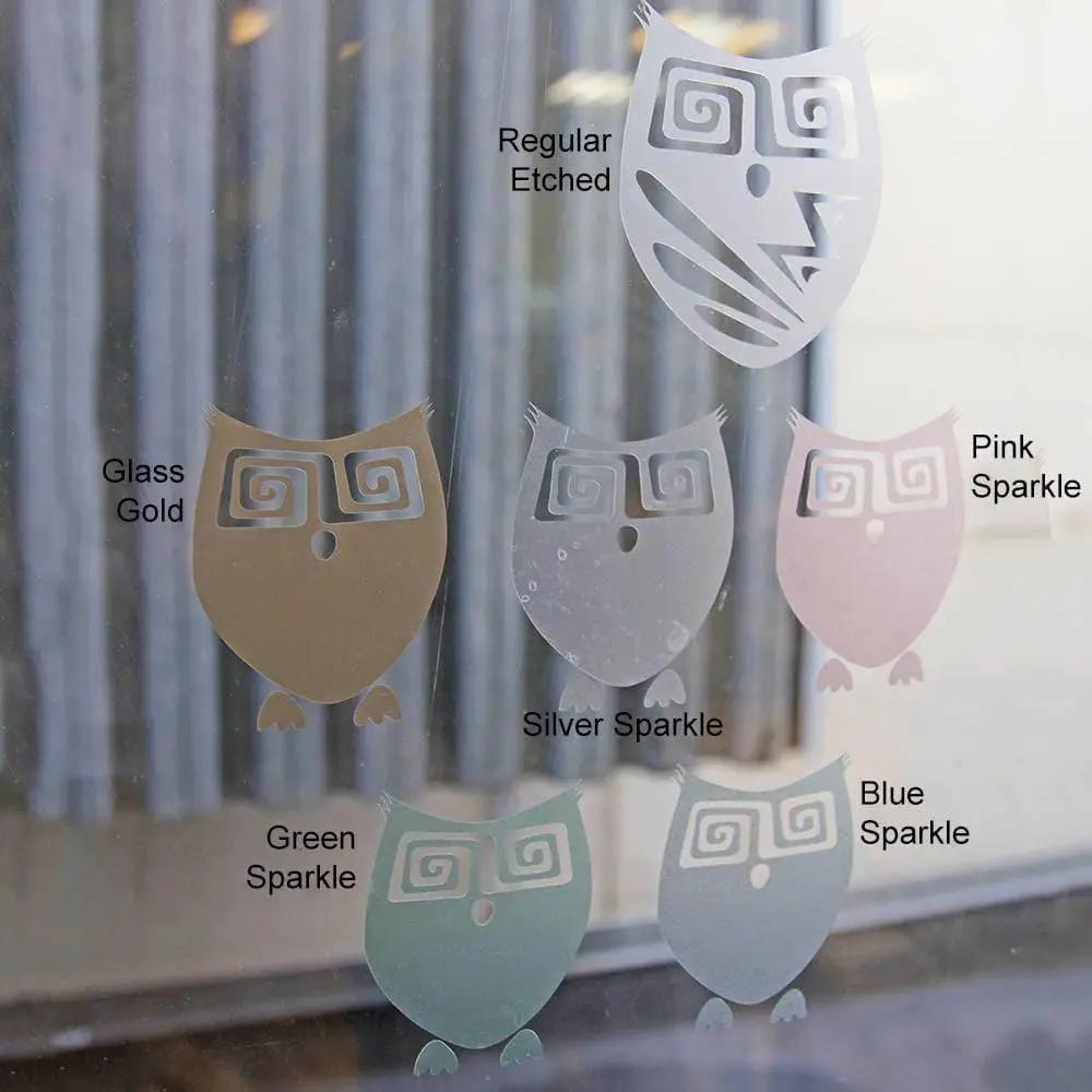 Owl-shaped frosted window film samples in various finishes: Glass Gold, Pink Sparkle, Silver Sparkle, Green Sparkle, and Blue Sparkle.