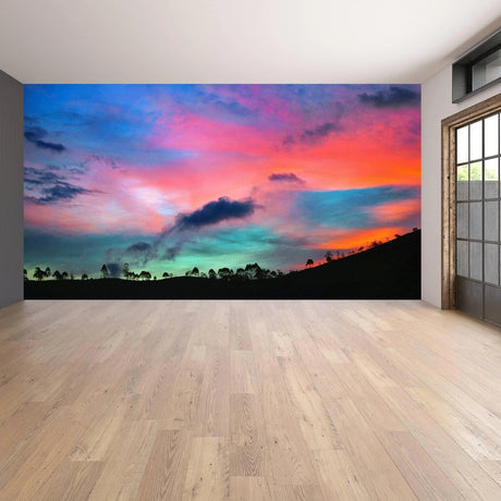 Vibrant sunset wall decals transforming a stylish home interior with a panoramic nature view.