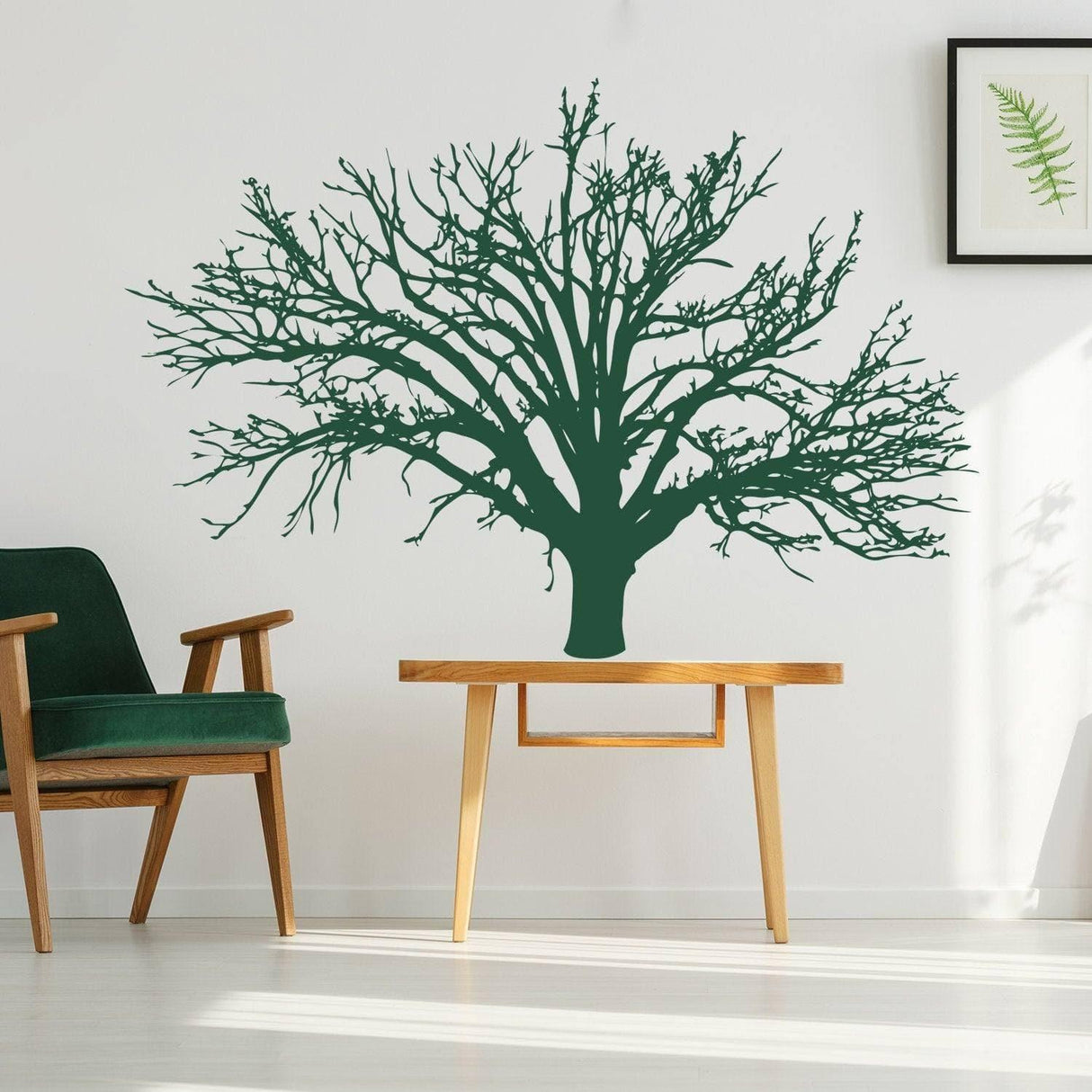 Nature's Serenity tree vinyl wall decal on a wall above a wooden table and green chair, enhancing interior decor.
