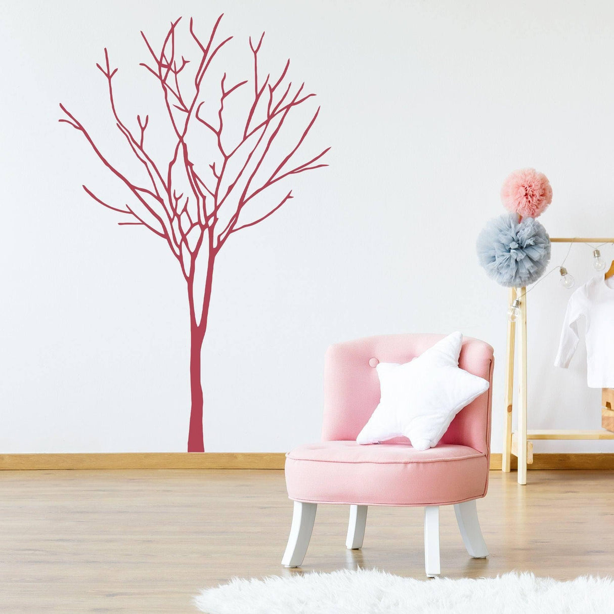 Vinyl wall decal of a tree design in a stylish room with pink chair and decor.