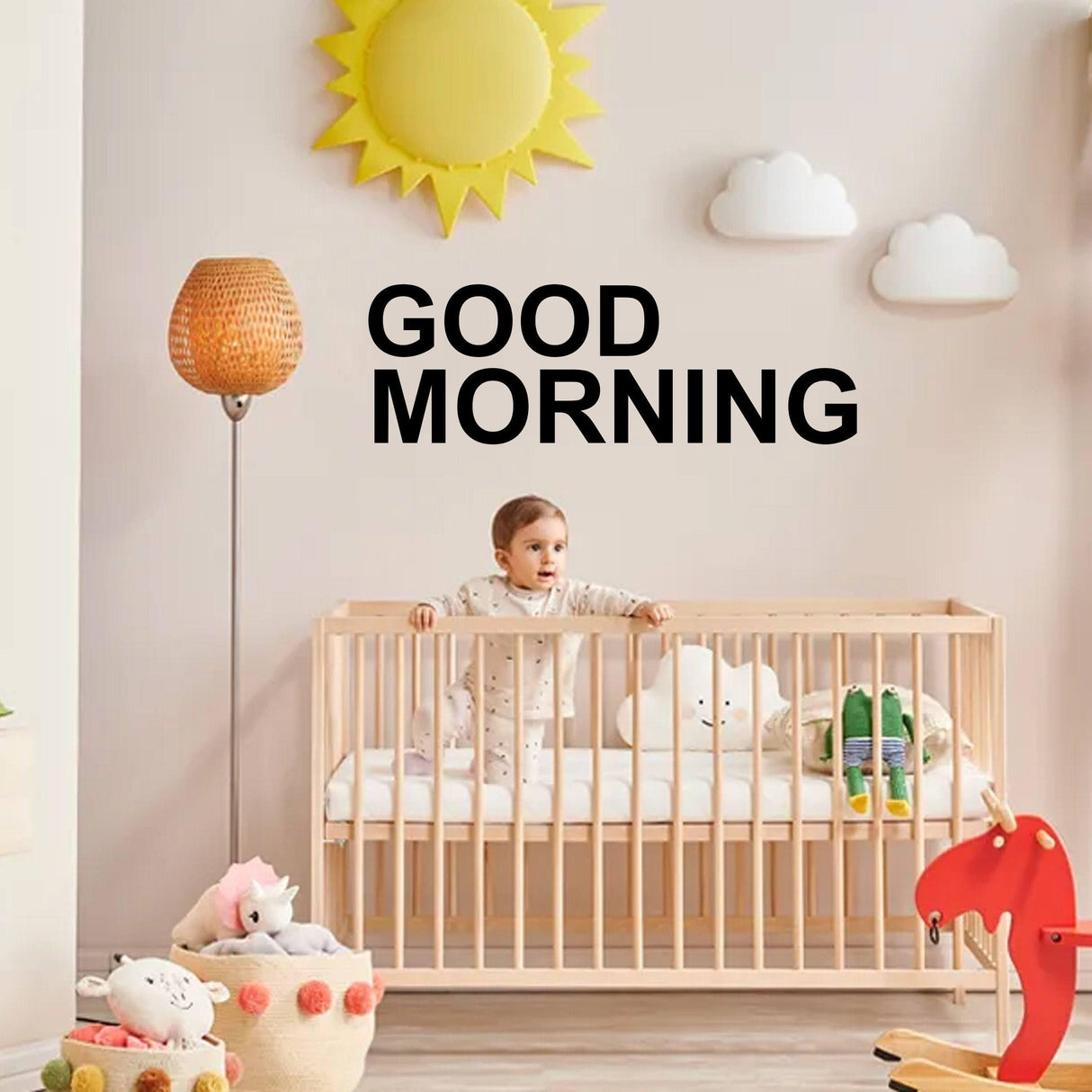 Child in a crib with a "GOOD MORNING" vinyl decal, bright nursery with playful decor and warm lighting.