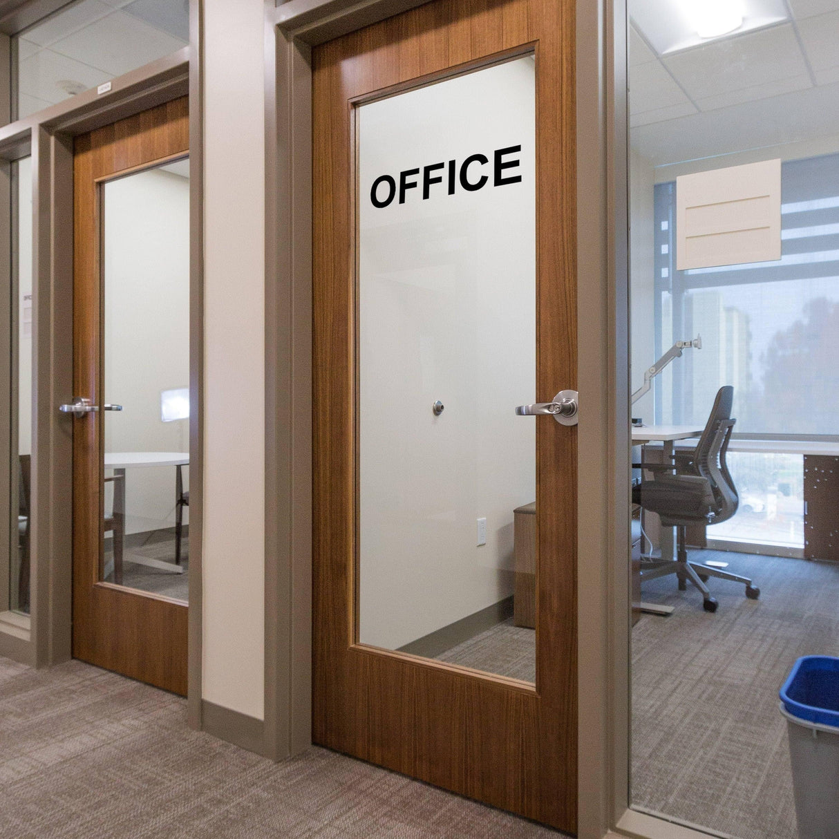 Professional office doors with clear vinyl letter decals spelling 'OFFICE' on glass panels.