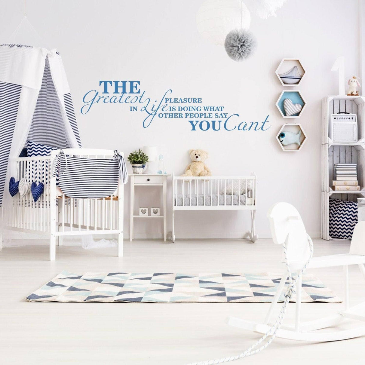 Inspirational wall decal with motivational quote in a stylish nursery with blue and white decor.