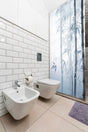 Bathroom featuring Tranquil Bamboo Forest vinyl shower door decal for privacy and serenity.