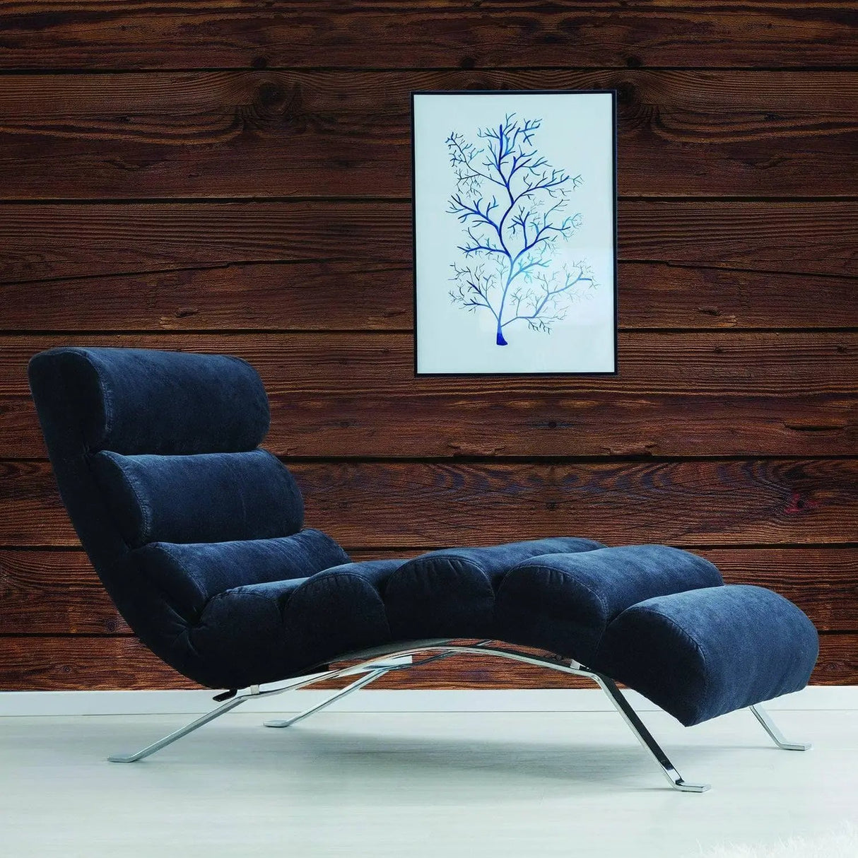 Stylish navy chair against rustic wood wall with framed blue tree artwork, perfect for modern decor.