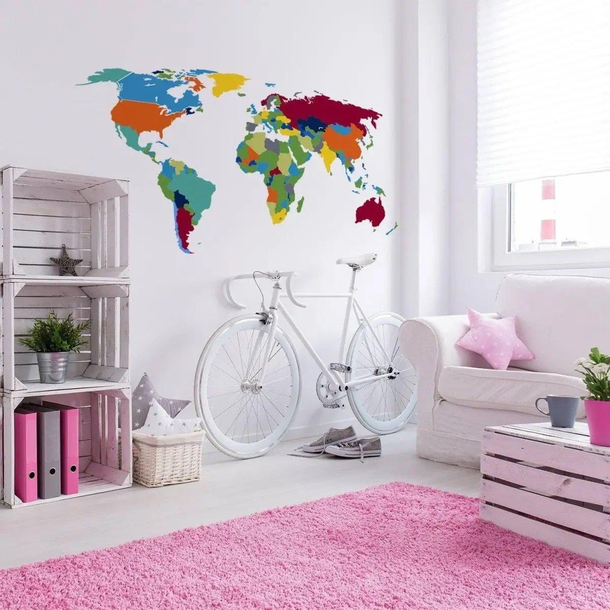 Colorful world map wall decal in modern living room with bicycle and pink rug for adventurous decor