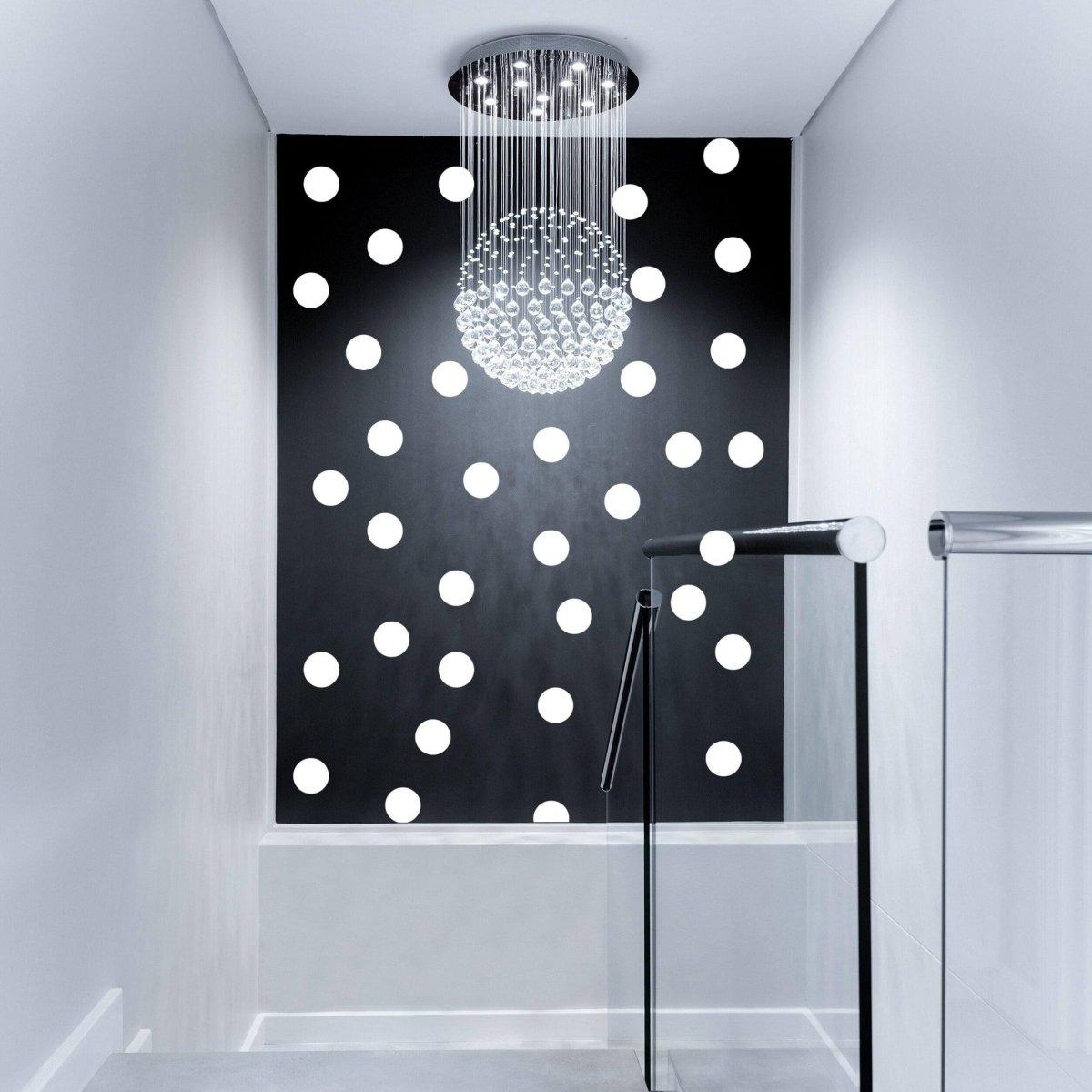 Stylish hallway featuring large white round dot wall stickers on a black wall, complemented by a modern chandelier.