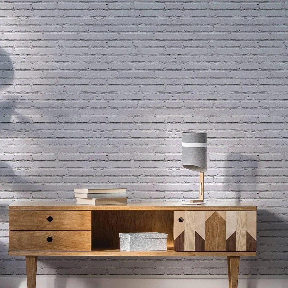 Peel and stick wallpaper featuring a modern brick design, enhancing a stylish wooden console table and lamp in a living room setting.