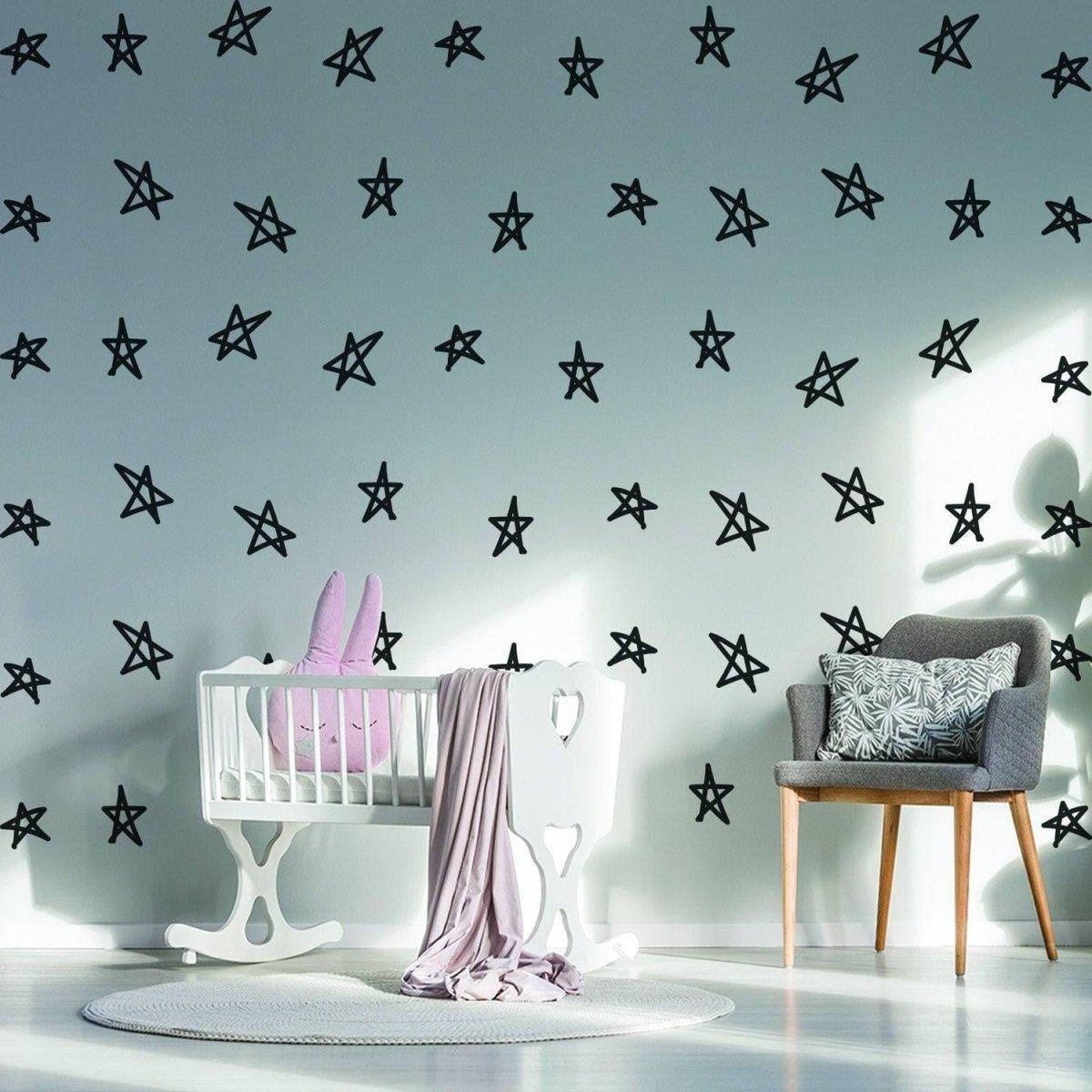 Black star stickers on nursery wall, enhancing baby shower decor with versatile and stylish touches.