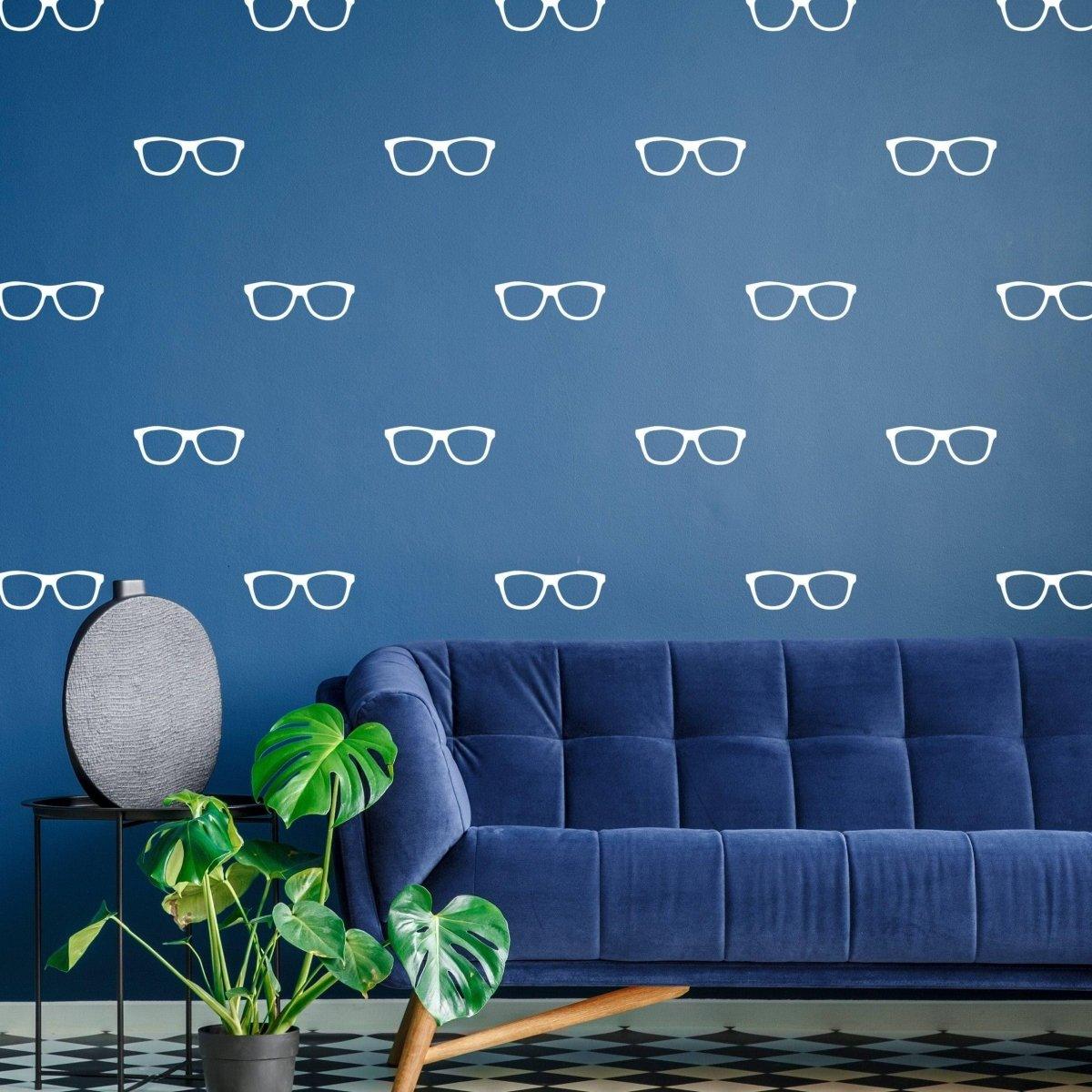 Blue wall with white glasses wall decals and a stylish blue sofa with a plant in a modern living room.