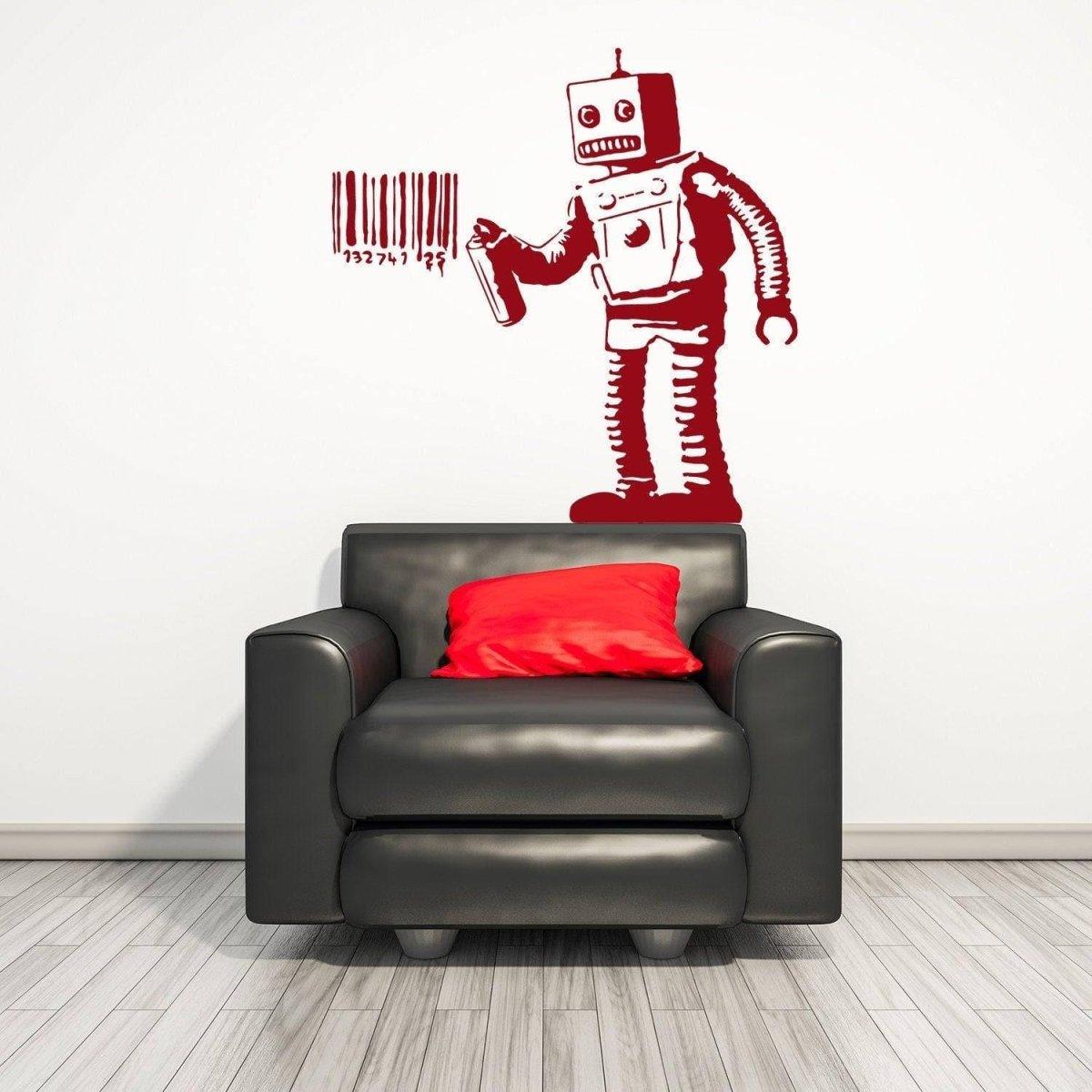 Street art robot vinyl decal in red on white wall near a black sofa with red cushion.