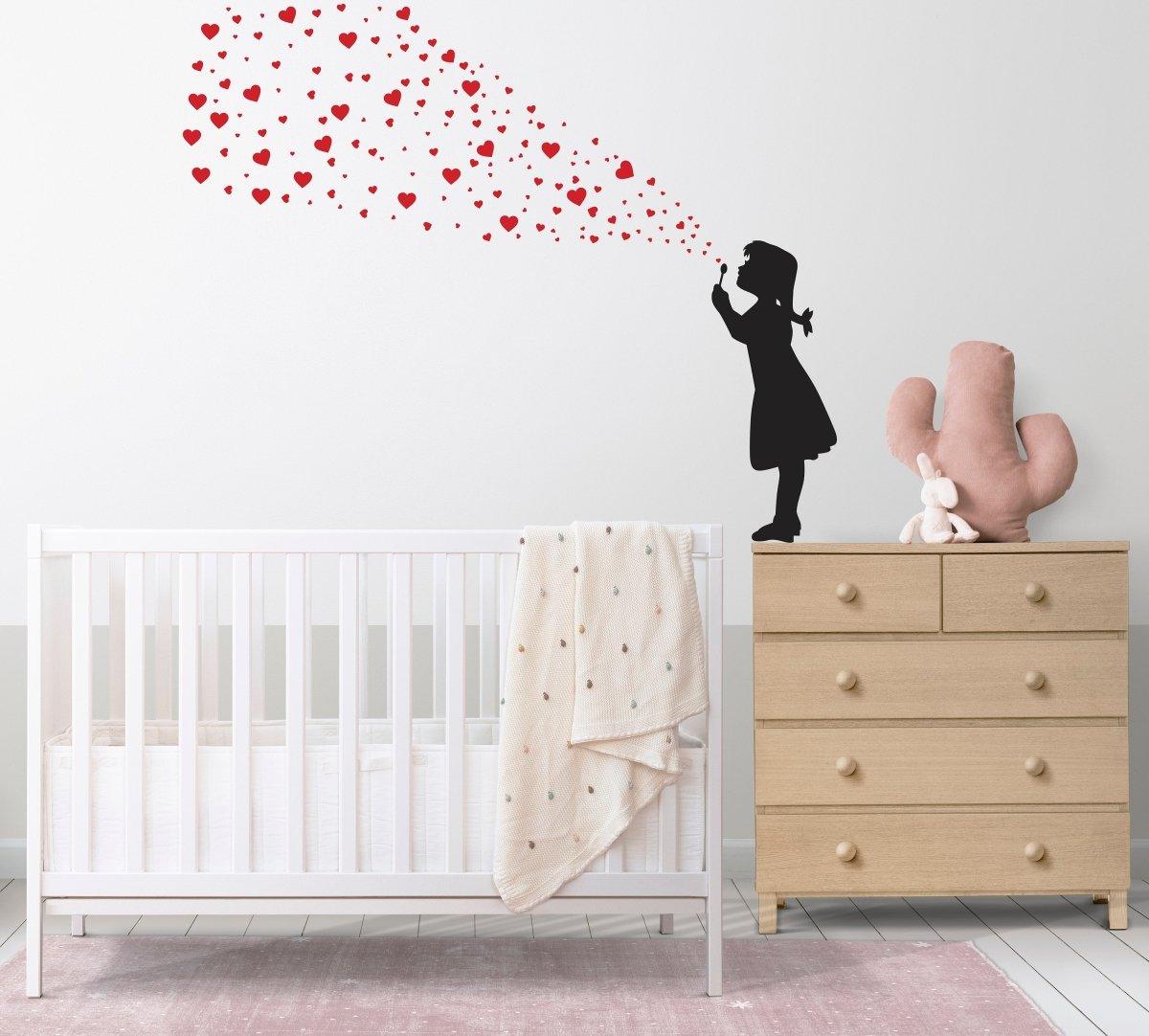 Graffiti art wall decal of a girl blowing red hearts, enhancing a child's nursery decor.