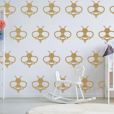 Bumblebee wall decals in a playful pattern on a nursery wall, featuring gold vinyl stickers.