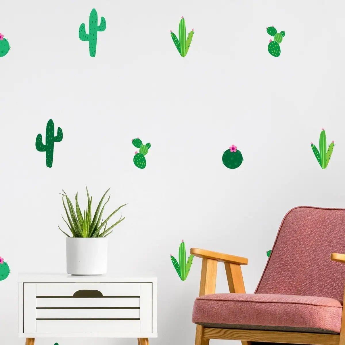 Vibrant cactus vinyl wall decals decor on white wall with a cozy chair and plant.
