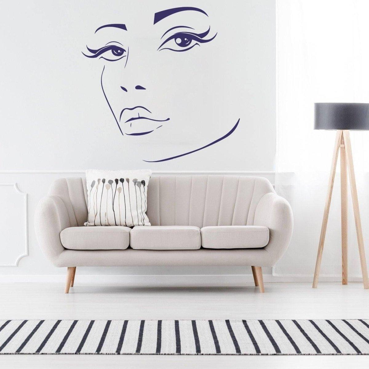 Charming woman face wall decal above a stylish sofa in a modern living room, adding artistic flair to interior design.