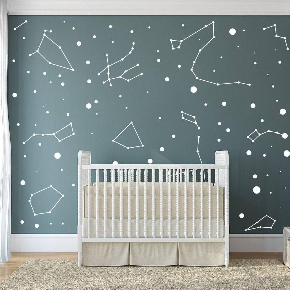 Celestial nursery wall featuring constellation stickers and star decals on teal background.