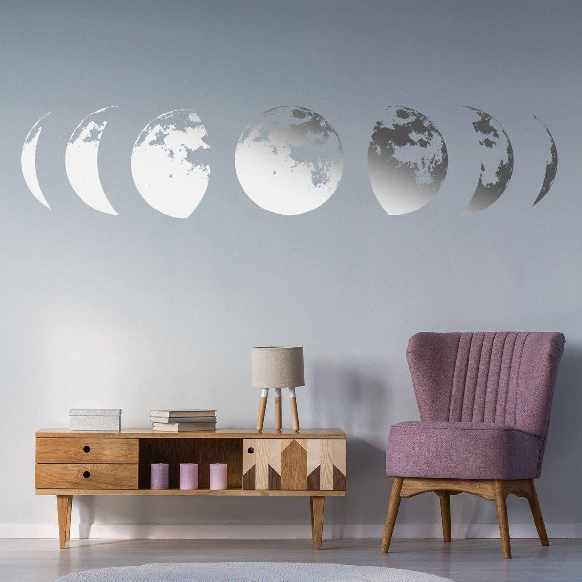 Moon phase wall sticker in modern living room, adding celestial decor above wooden console and pink accent chair.